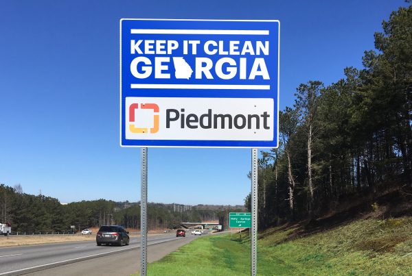 Keep It Clean Georgia sponsor sign with the Piedmont logo beside a highway