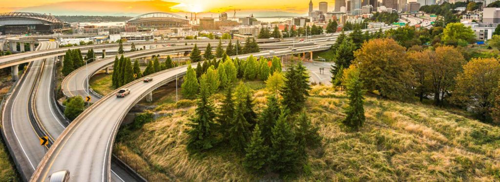 Highway ramps and the Seattle, Washington, skyline at sunset