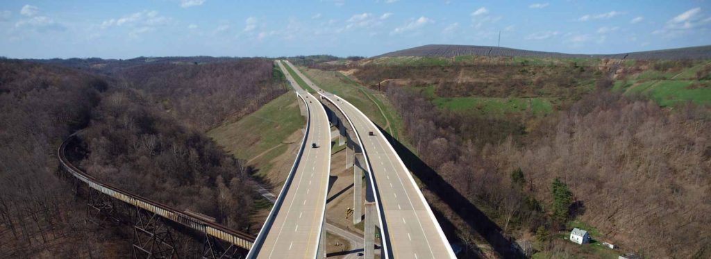 Divided highway crossing wooded hills on a viaduct in Pennsylvania